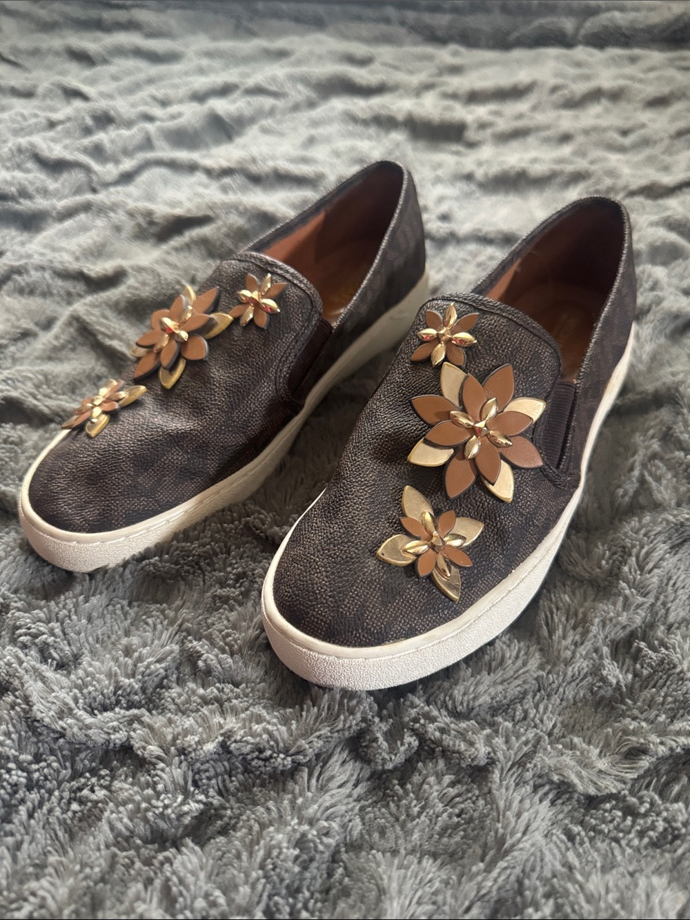 MICHAEL Michael Kors Brown Slip-On Sneakers with Gold Floral Embellishments